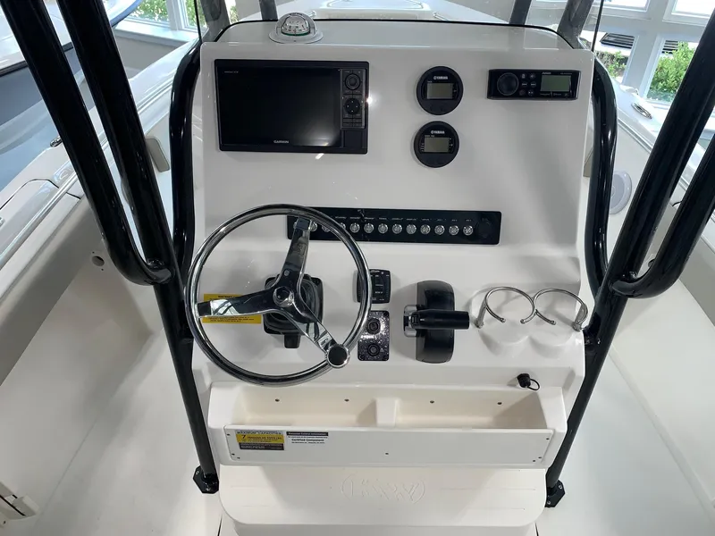Slide: The Image of 2024 Key West 219 FS boat console with steering wheel and navigation controls. - 4