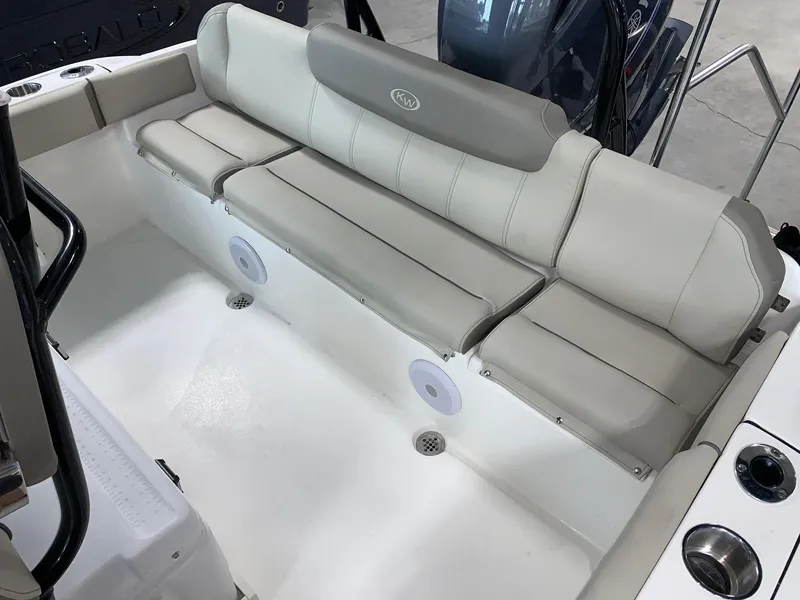 Slide: The Image of 2024 Key West 219 FS boat with cushioned seating and built-in speakers. - 9