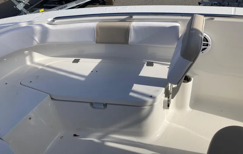 Slide: The Image of 2024 Robalo R200 Center Console boat seating area with storage compartment. - 10