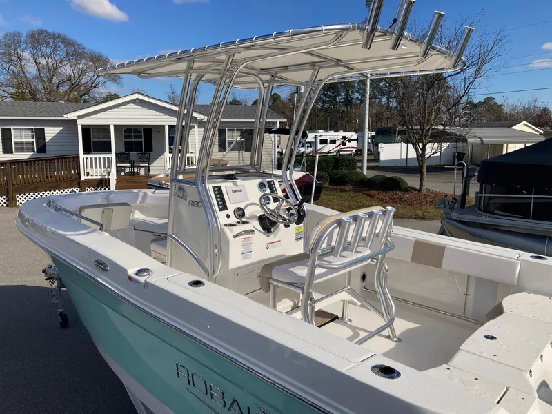 Slide: The Image of 2024 Robalo R200 Center Console boat with T-top and dual helm seats. - 4