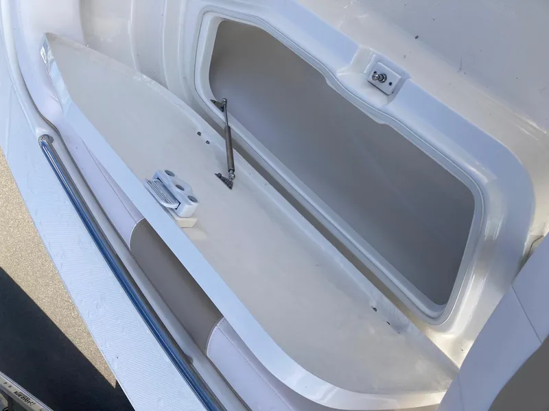 Slide: The Image of 2024 Robalo R200 Center Console storage compartment open. - 11