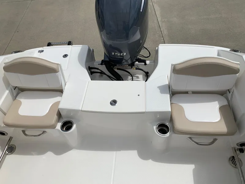 Slide: The Image of 2024 Robalo R200 Center Console boat with twin seats and outboard motor. - 18