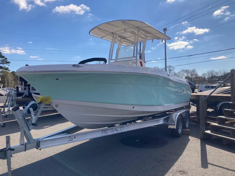 Slide: The Image of 2024 Robalo R200 Center Console boat on a trailer under a clear sky. - 3
