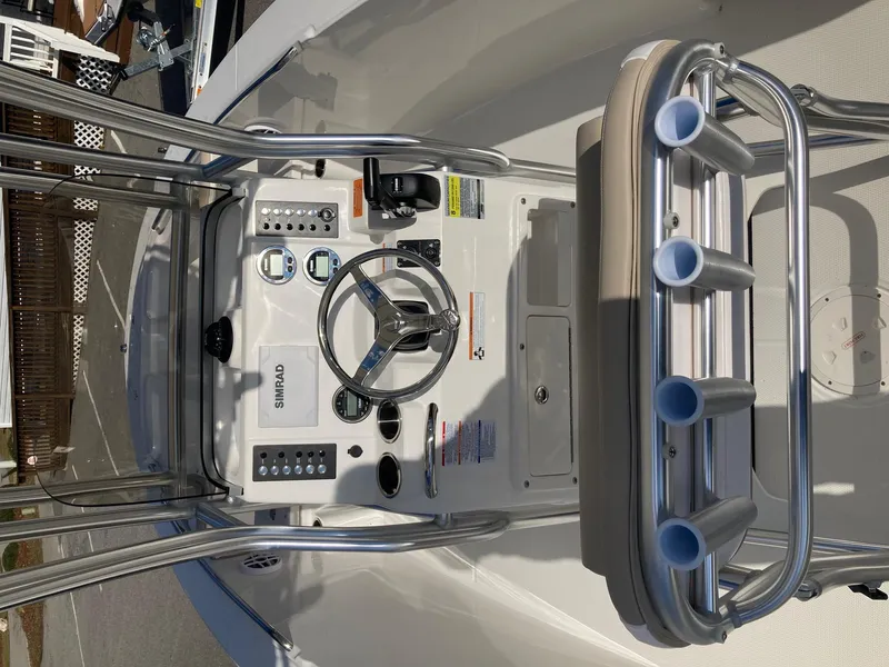 Slide: The Image of 2024 Robalo R200 Center Console boat helm with steering wheel and controls. - 5