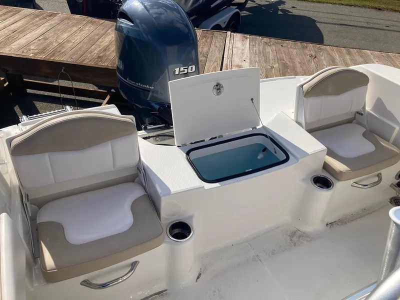 Slide: The Image of 2024 Robalo R200 Center Console boat with seating and storage compartments. - 7