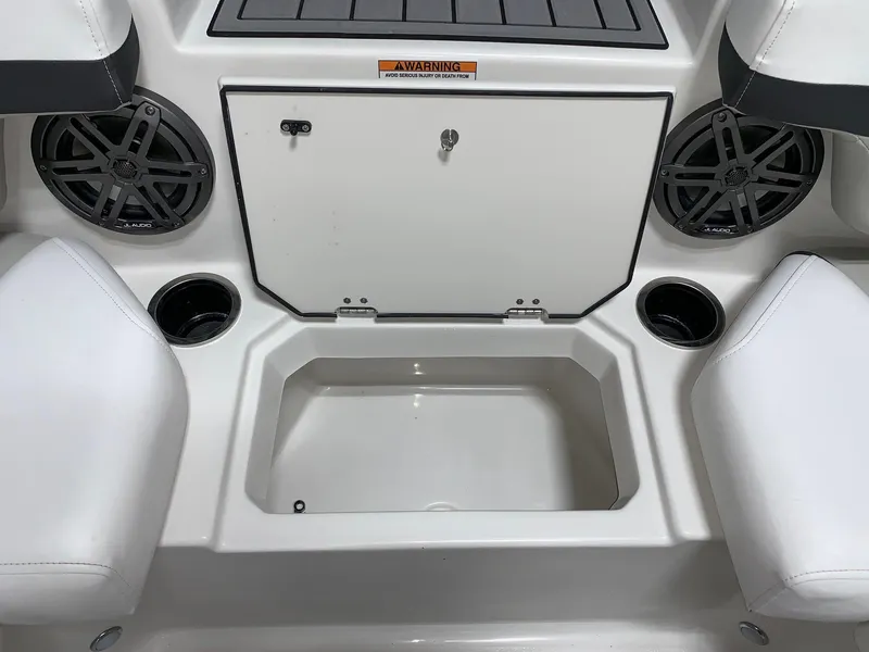 Slide: The Image of 2024 Starcraft SVX 191 boat interior with storage compartment and cup holders. - 11