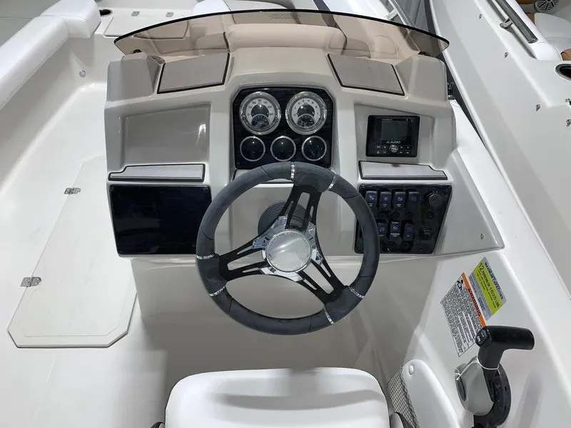 Slide: The Image of 2024 Starcraft SVX 191 boat dashboard with steering wheel and control panel. - 6