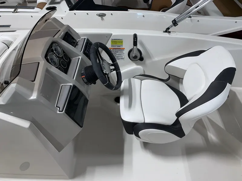 Slide: The Image of 2024 Starcraft SVX 191 boat cockpit with steering wheel and captain's chair. - 8