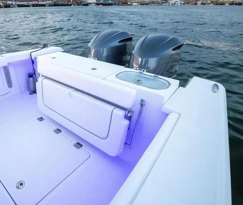Slide: The Image of 2024 Southport 27 boat with dual outboard engines and illuminated deck. - 4