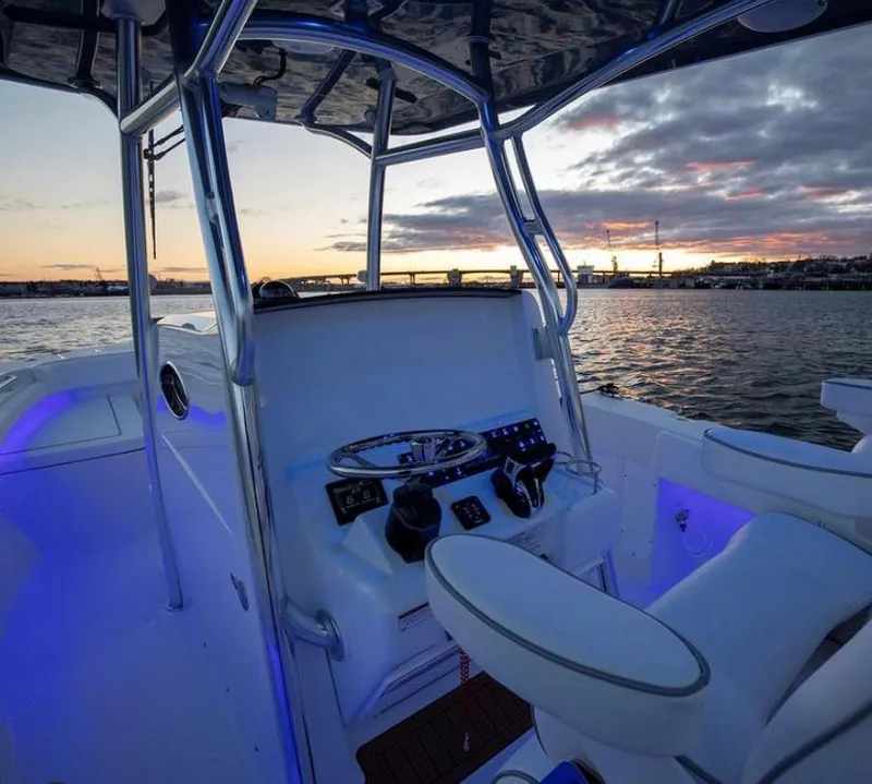 Slide: The Image of 2024 Southport 27 boat interior at sunset, featuring modern helm and seating. - 5