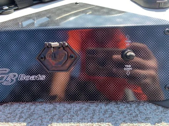 Slide: The Image of 2021 G3 Sportsman 1710 PFX boat control panel with trim switch. - 13