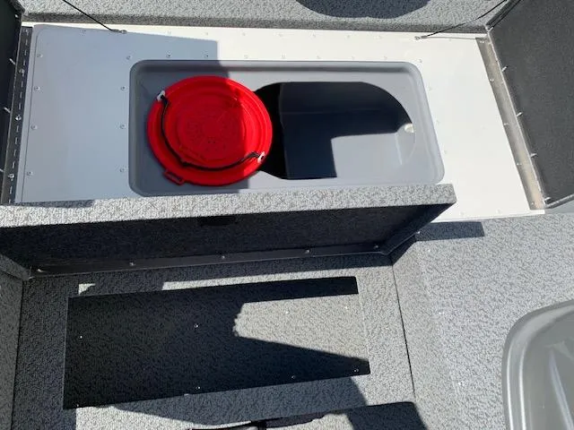 Slide: The Image of 2021 G3 Sportsman 1710 PFX boat storage compartment with red bucket. - 5