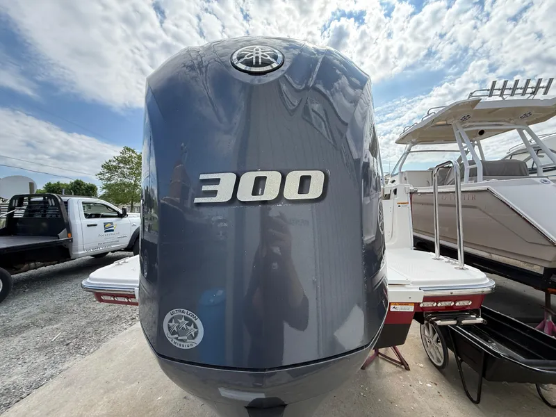 Slide: The Image of 2020 Ranger Tugs R-27 with Yamaha 300 outboard engine, docked under a cloudy sky. - 5
