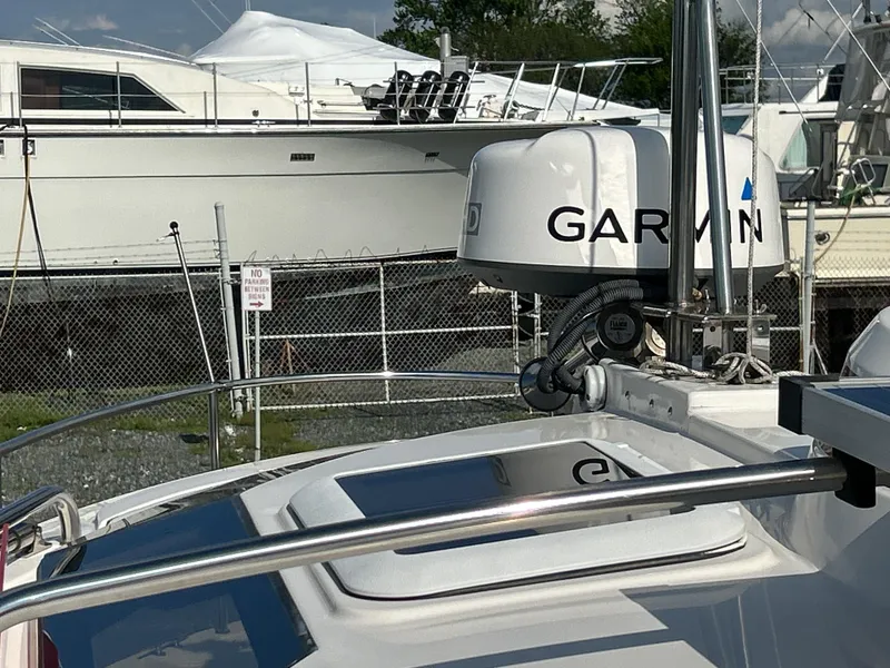 Slide: The Image of 2020 Ranger Tugs R-27 boat with Garmin radar, docked near other vessels. - 8