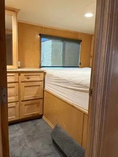 Slide: The Image of Boat helm station with wooden interior, steering wheel, and black chair, Custom The Entourage Shares 20 & 35, 2005. - 10