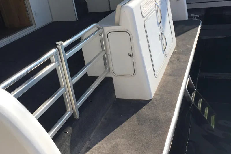 Slide: The Image of Upper deck of 2005 Custom The Entourage Shares 20 & 35 yacht with seating and grill. - 22