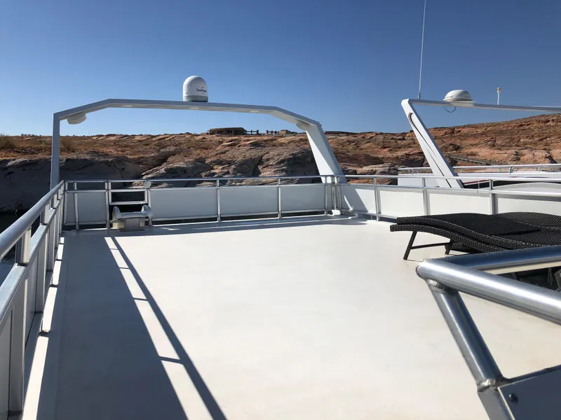 Slide: The Image of Top deck of 2005 Custom The Entourage Shares 20 & 35 yacht with lounge chairs. - 3