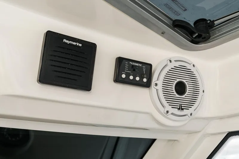 Slide: The Image of Control panel and speaker system on a 2019 Boston Whaler 315 Conquest boat. - 100