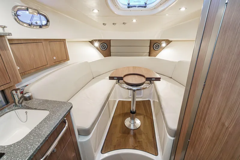 Slide: The Image of Luxurious interior of 2019 Boston Whaler 315 Conquest with elegant seating and wooden accents. - 106