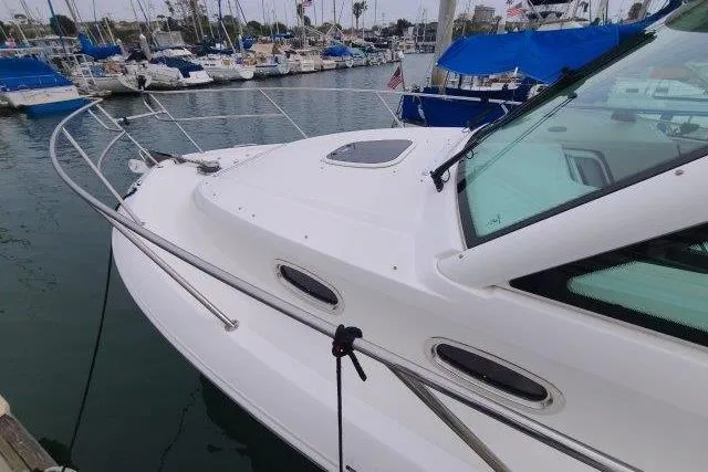 Slide: The Image of 2019 Boston Whaler 315 Conquest docked in a marina with sailboats. - 11