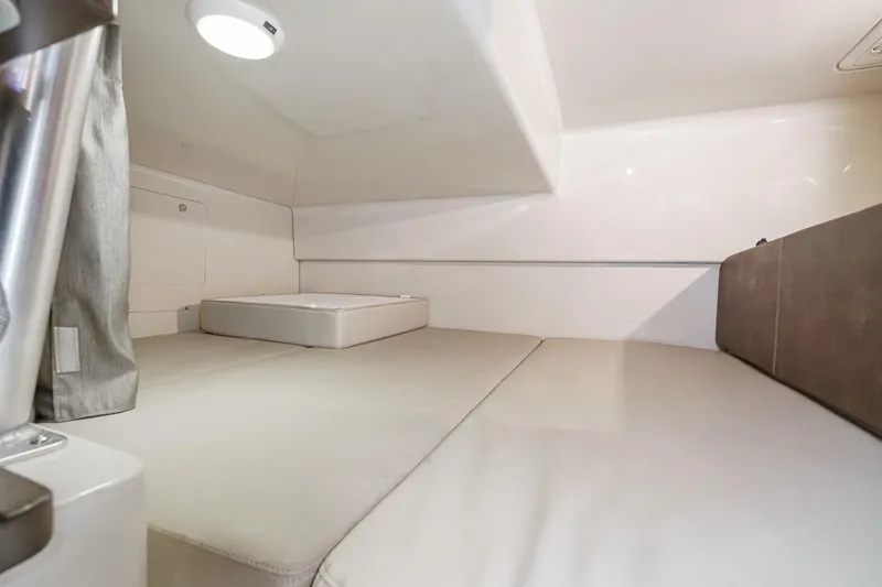 Slide: The Image of 2019 Boston Whaler 315 Conquest cabin interior with cushioned seating and modern design. - 114