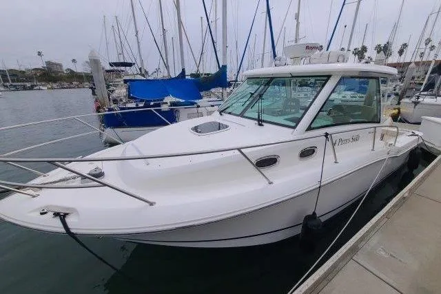 Slide: The Image of 2019 Boston Whaler 315 Conquest docked in a marina with sailboats. - 12