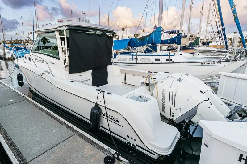 Slide: The Image of 2019 Boston Whaler 315 Conquest docked with Mercury outboard engines. - 126