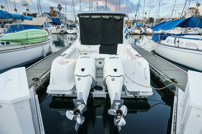 Slide: The Image of 2019 Boston Whaler 315 Conquest docked at marina with twin engines. - 127
