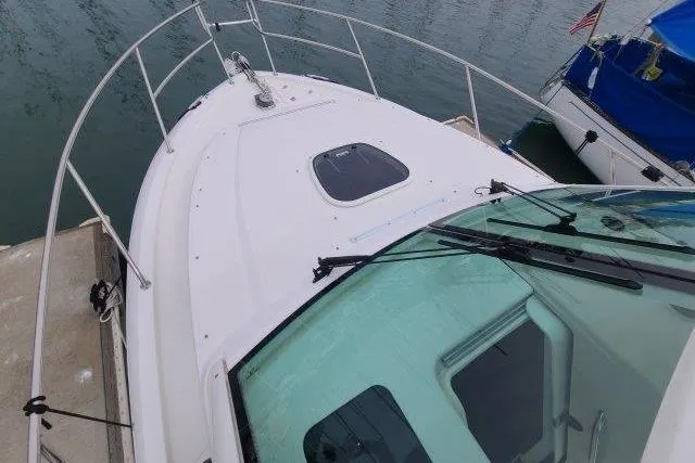Slide: The Image of 2019 Boston Whaler 315 Conquest boat docked, showing bow and windshield. - 13