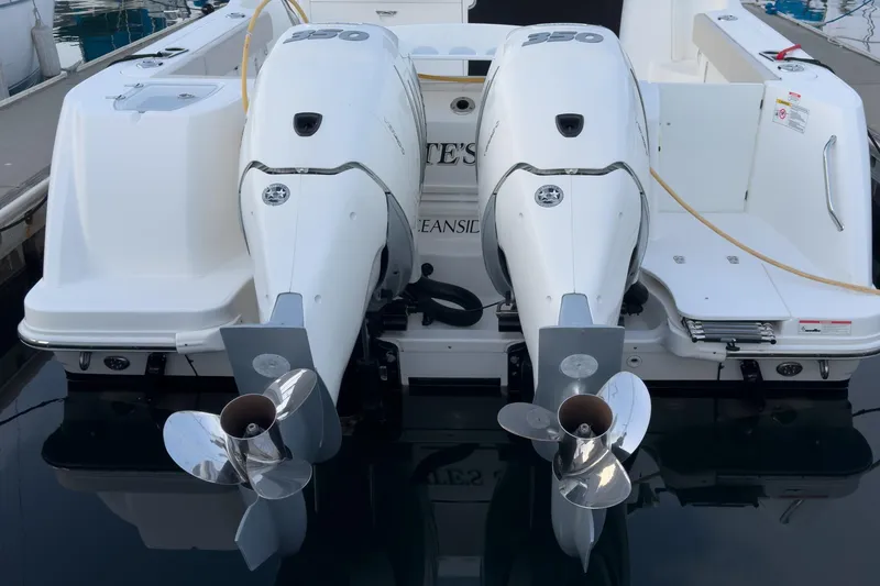 Slide: The Image of 2019 Boston Whaler 315 Conquest with dual outboard engines at dockside. - 130