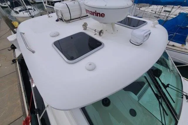 Slide: The Image of 2019 Boston Whaler 315 Conquest boat deck with hatches and marine equipment. - 15
