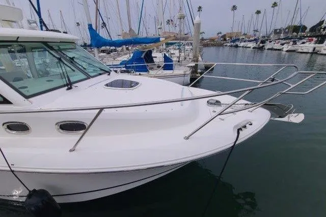 Slide: The Image of 2019 Boston Whaler 315 Conquest docked in a marina with sailboats. - 2