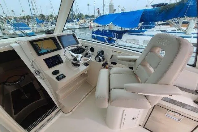 Slide: The Image of 2019 Boston Whaler 315 Conquest helm with modern navigation equipment and comfortable seating. - 28