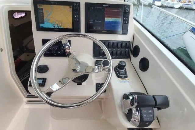 Slide: The Image of 2019 Boston Whaler 315 Conquest helm with navigation screens and controls. - 30