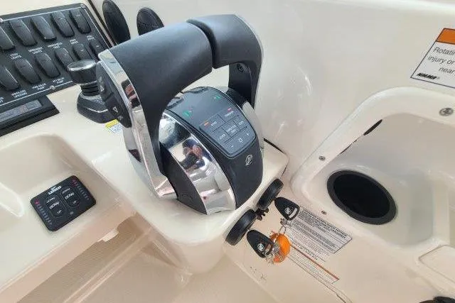 Slide: The Image of Close-up of 2019 Boston Whaler 315 Conquest throttle controls and dashboard. - 36