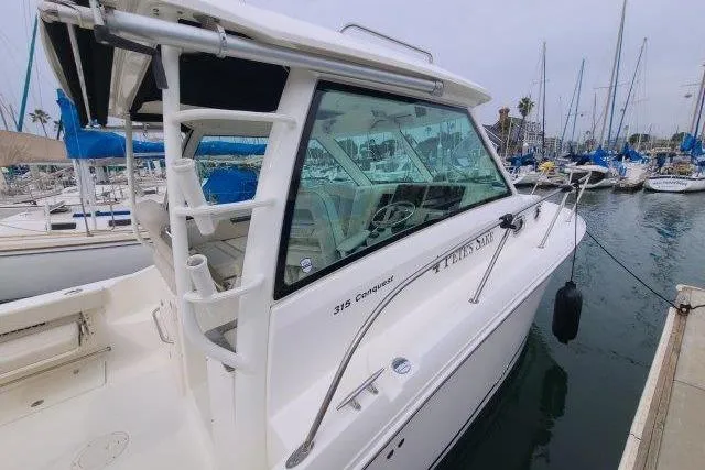 Slide: The Image of 2019 Boston Whaler 315 Conquest boat docked in a marina. - 4