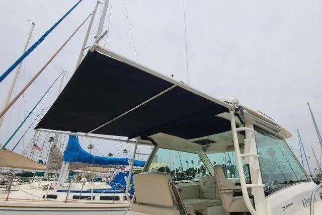 Slide: The Image of 2019 Boston Whaler 315 Conquest boat with extended canopy in marina setting. - 41