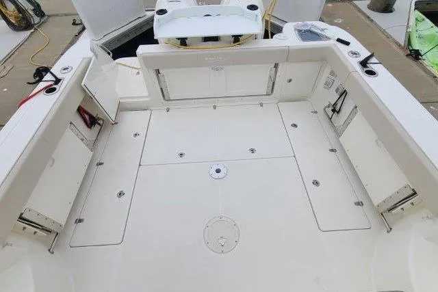 Slide: The Image of 2019 Boston Whaler 315 Conquest boat deck with storage compartments and seating. - 44