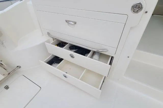 Slide: The Image of 2019 Boston Whaler 315 Conquest boat storage drawers, open and organized. - 45