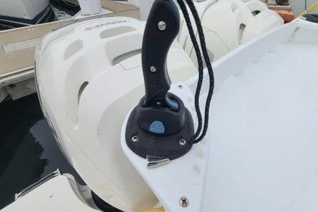 Slide: The Image of Boston Whaler 315 Conquest 2019 boat detail with mounted knife and dual engines. - 48