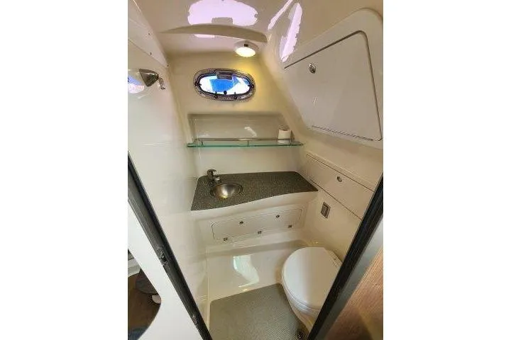 Slide: The Image of 2019 Boston Whaler 315 Conquest boat bathroom with sink, toilet, and storage. - 67