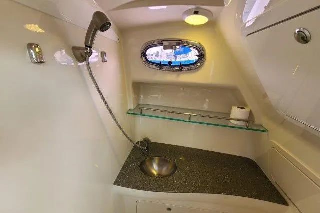 Slide: The Image of 2019 Boston Whaler 315 Conquest bathroom with sink, shower, and porthole window. - 69