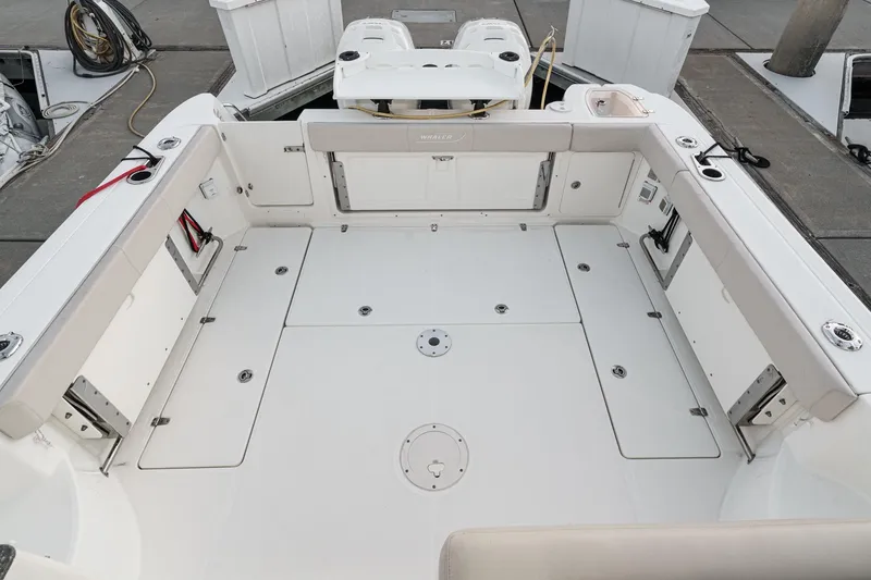 Slide: The Image of 2019 Boston Whaler 315 Conquest boat deck, spacious and well-equipped for fishing. - 74
