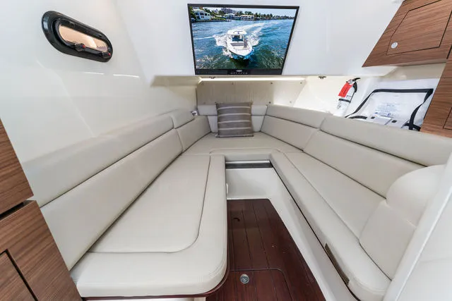 Slide: The Image of 2019 Boston Whaler 315 Conquest boat docked at marina, showcasing interior seating and helm. - 88