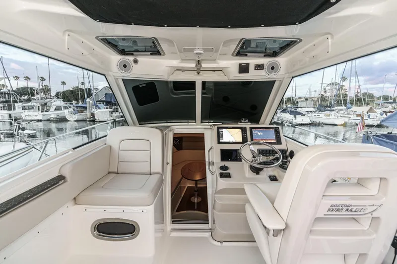 Slide: The Image of Interior of a 2019 Boston Whaler 315 Conquest boat with marina view. - 92