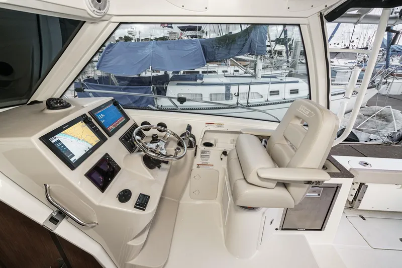 Slide: The Image of 2019 Boston Whaler 315 Conquest helm with navigation screens and comfortable captain's chair. - 94
