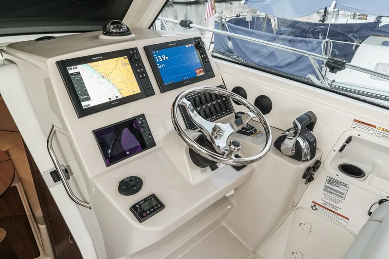 Slide: The Image of Helm of 2019 Boston Whaler 315 Conquest with navigation screens and controls. - 95