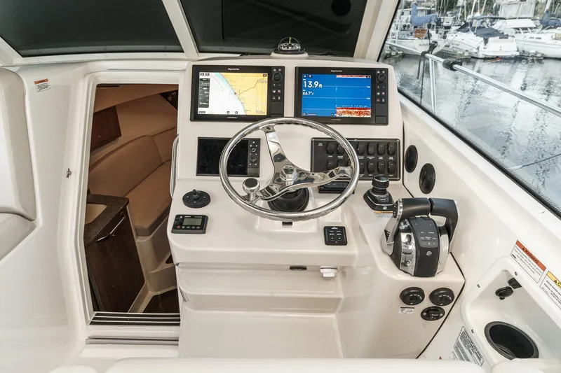 Slide: The Image of 2019 Boston Whaler 315 Conquest helm with navigation screens and controls. - 96