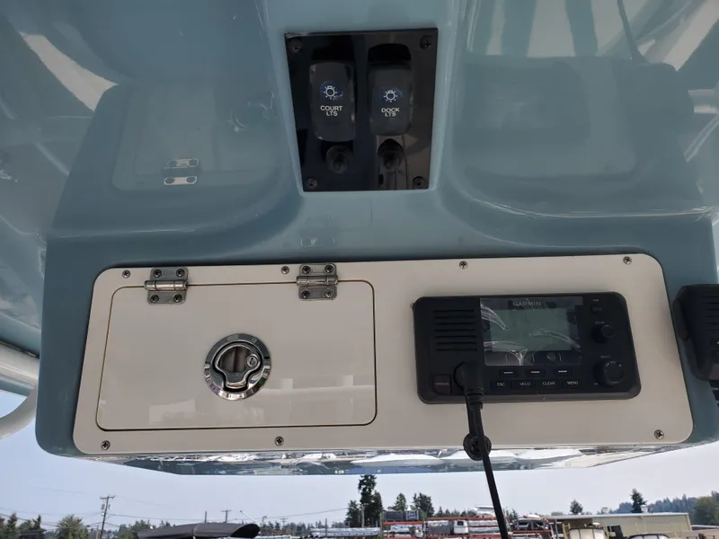 Slide: The Image of 2022 Sailfish 220 WAC boat dashboard with control panel and radio system. - 14