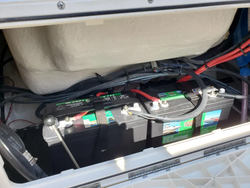 Slide: The Image of Battery compartment of 2022 Sailfish 220 WAC boat with wiring and connections. - 16